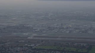 7.6K aerial stock footage of LAX in a thick cloud covering, sunrise, Los Angeles, California Aerial Stock Footage | AX0156_179E