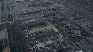 7.6K aerial stock footage flying over LAX and parked airplanes, sunrise, Los Angeles, California Aerial Stock Footage | AX0156_181E