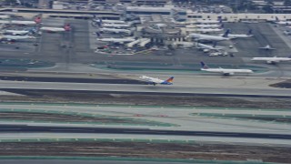 7.6K aerial stock footage tracking a jet taking off from LAX in the morning, California Aerial Stock Footage | AX0156_191