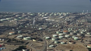 AX0157_005 - 7.6K aerial stock footage flying over oil refineries, cloudy, El Segundo, California