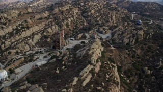 AX0157_042E - 7.6K aerial stock footage orbiting over the Rocektdyne aerospace testing facility and test stands, Brandeis, California