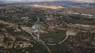 AX0157_044 - 7.6K aerial stock footage tilting down on the Rocektdyne Aerospace Testing Facility, Brandeis, California