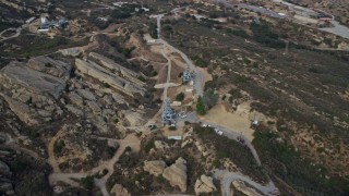 AX0157_045E - 7.6K aerial stock footage orbiting test stands at Rocektdyne Aerospace Testing Facility on a hilltop, Brandeis, California