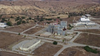 AX0157_048 - 7.6K aerial stock footage approaching a building at the Rocektdyne aerospace testing facility, Brandeis, California