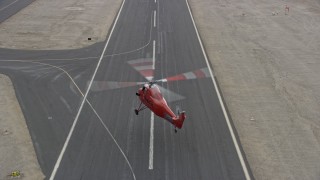 7.6K aerial stock footage of a Sikorsky S58T flying over the runway and landing at Whiteman Airport in Pacoima, California Aerial Stock Footage | AX0157_089E