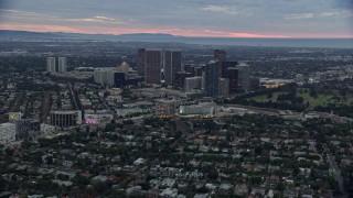 7.6K aerial stock footage flying by Waldorf Astoria and Beverly Hilton toward office buildings, twilight, Century City, California Aerial Stock Footage | AX0158_023E