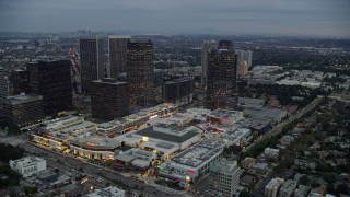 7.6K aerial stock footage passing by office buildings and shopping mall, twilight, Century City, California Aerial Stock Footage | AX0158_025