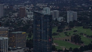 7.6K aerial stock footage orbiting the top of Ten Thousand, a luxury condominium building, Century City, California at twilight Aerial Stock Footage | AX0158_029E