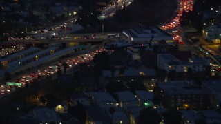 AX0158_070E - 7.6K aerial stock footage tracking LAPD helicopter at twilight in Hollywood, California