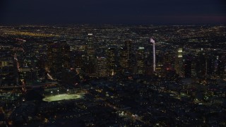 7.6K aerial stock footage approaching skyscrapers lit up for the night in Downtown Los Angeles, California Aerial Stock Footage | AX0158_074