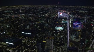 7.6K aerial stock footage orbiting and tilt to a bird's eye of Wilshire Grand Center in Downtown Los Angeles, California at night Aerial Stock Footage | AX0158_121E