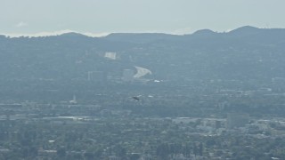 7.6K aerial stock footage tracking a Cessna flying over San Fernando Valley, cloudy, California Aerial Stock Footage | AX0159_003