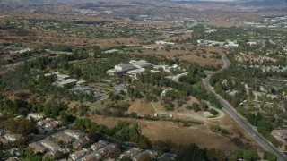 7.6K aerial stock footage of a wide shot of California Institute of the Arts nestled among suburban neighborhoods, Santa Clarita, California Aerial Stock Footage | AX0159_023