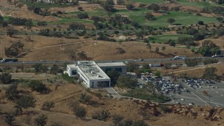 7.6K aerial stock footage of Academy of the Canyons and Interstate 5 with light traffic, Santa Clarita, California Aerial Stock Footage | AX0159_024