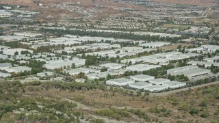 AX0159_033E - 7.6K aerial stock footage of rows of office buildings and warehouses, Valencia, California