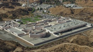 AX0159_042 - 7.6K aerial stock footage orbiting a supermax correctional facility, Valencia, California