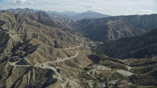 7.6K aerial stock footage flying over a road winding through the canyons, Newhall, California Aerial Stock Footage | AX0159_055E