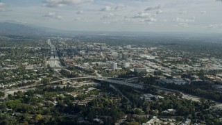 7.6K aerial stock footage flying over an office building to approach Pasadena City Hall, California Aerial Stock Footage | AX0159_104E