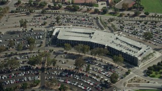 AX0159_132 - 7.6K aerial stock footage approaching the Cal Poly parking garage in Pomona, California