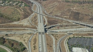 AX0159_133 - 7.6K aerial stock footage of a reverse view of the I-10 / Hwy 57 / Hwy 71 Interchange in Pamona, California