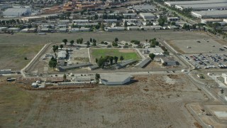 7.6K aerial stock footage approaching the California Institution for Men prison in Chino, California Aerial Stock Footage | AX0159_142