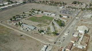 7.6K aerial stock footage circling buildings at the California Institution for Men, Chino, California Aerial Stock Footage | AX0159_143