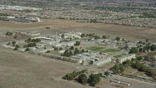 7.6K aerial stock footage orbiting California Institution for Men buildings in Chino, California Aerial Stock Footage | AX0159_144E