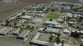 7.6K aerial stock footage flying by the California Institution for Men in Chino, California Aerial Stock Footage | AX0159_146