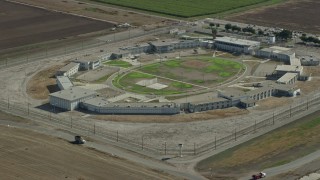 7.6K aerial stock footage flying by the East Yard of the California Institution for Men, Chino, California Aerial Stock Footage | AX0159_147