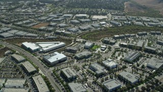 7.6K aerial stock footage flying over and orbit office buildings in a business park, Irvine, California Aerial Stock Footage | AX0159_175E