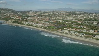 AX0159_200 - 7.6K aerial stock footage of beachfront mansions by Dana Strands Beach in Dana Point, California