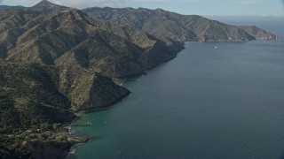 7.6K aerial stock footage following the rugged coastline of Santa Catalina Island, California toward a campground Aerial Stock Footage | AX0159_266E