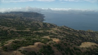 7.6K aerial stock footage flying over hills toward the coast of Santa Catalina Island, California Aerial Stock Footage | AX0160_001