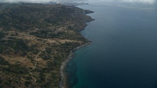 AX0160_002E - 7.6K aerial stock footage approaching the coast from hills on Santa Catalina Island, California