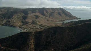 7.6K aerial stock footage of a reverse view of the Two Harbors island community in Santa Catalina Island, California Aerial Stock Footage | AX0160_010E