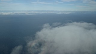 AX0160_022E - 7.6K aerial stock footage flying over low level clouds over the Pacific Ocean off the coast of Southern California