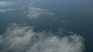 AX0160_028E - 7.6K aerial stock footage flying over wispy clouds and open water in the Pacific Ocean, Southern California