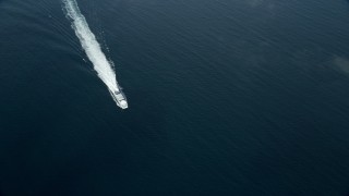 AX0160_030E - 7.6K aerial stock footage flying over clouds over open water to reveal a ferry off the coast of Southern California