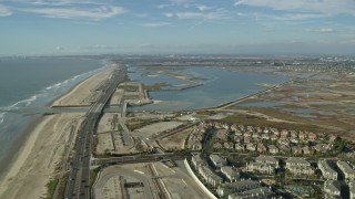 7.6K aerial stock footage flying over Hwy 1 and beach to Bolsa Chica Basin State Marine Conservation Area, Huntington Beach, California Aerial Stock Footage | AX0160_046