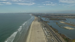 AX0160_047E - 7.6K aerial stock footage of Hwy 1 and Bolsa Chica Basin State Marine Conservation Area, Huntington Beach, California