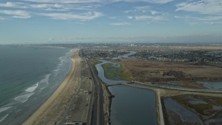 AX0160_049 - 7.6K aerial stock footage of the beach and Hwy 1 by Bolsa Chica State Marine Conservation Area, Huntington Beach, California