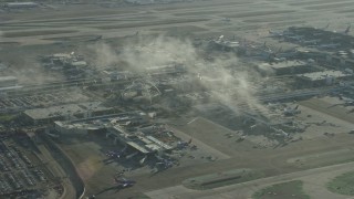 AX0161_048E - 7.6K aerial stock footage of a reverse view of the control tower and terminals at LAX, California