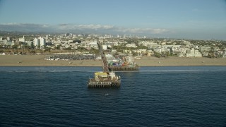 7.6K aerial stock footage flying by the end of Santa Monica Pier in Santa Monica, California Aerial Stock Footage | AX0161_078E