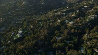 7.6K aerial stock footage flying away from hillside mansions in Beverly Hills, California Aerial Stock Footage | AX0161_103