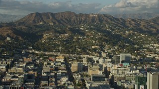 AX0161_121 - 7.6K aerial stock footage of the Hollywood Sign, hillside homes, and office buildings in Hollywood, California