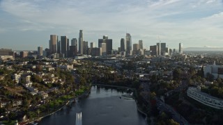 7.6K aerial stock footage flying over Echo Park Lake to approach the skyline in Downtown Los Angeles, California Aerial Stock Footage | AX0162_001E