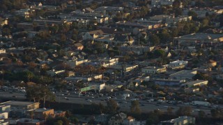 AX0162_060E - 7.6K aerial stock footage tracking an LAPD helicopter approaching the I-10 freeway in Pico-Union, Los Angeles, California