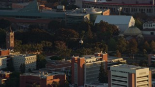 AX0162_062E - 7.6K aerial stock footage tracking an LAPD helicopter flying over USC in University Park, Los Angeles, California