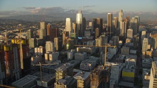 AX0162_069E - 7.6K aerial stock footage of skyscrapers seen from Oceanwide Plaza at sunset in Downtown Los Angeles, California