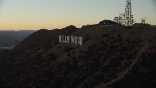 AX0162_107E - 7.6K aerial stock footage approaching the famous Hollywood Sign at twilight in Los Angeles, California